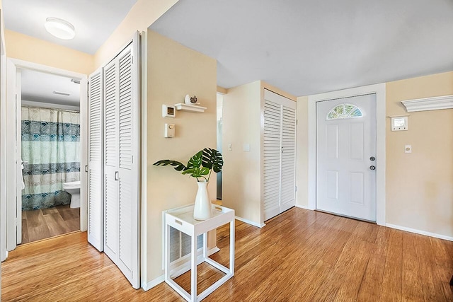 entryway featuring baseboards and light wood finished floors