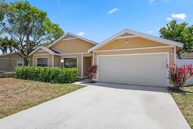 ranch-style house featuring a garage, stucco siding, and concrete driveway