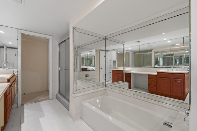 bathroom featuring recessed lighting, a shower stall, a bath, and vanity