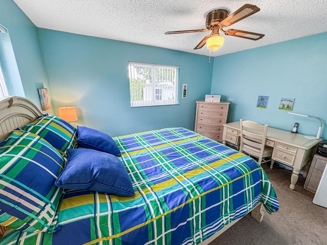 bedroom with a textured ceiling, carpet, and a ceiling fan