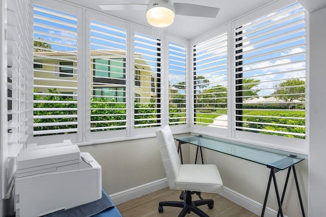 office space with baseboards, a ceiling fan, and wood finished floors