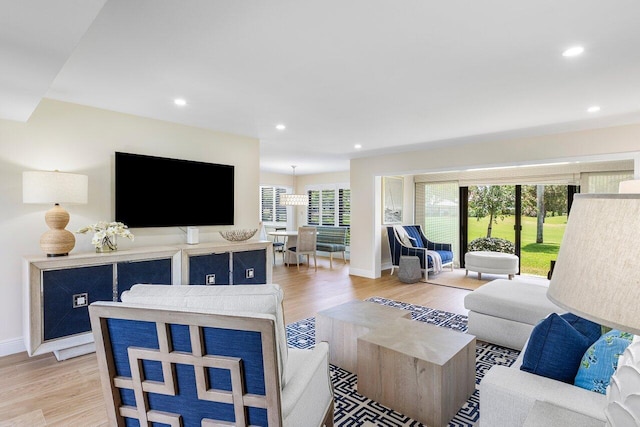 living room featuring light wood-type flooring, recessed lighting, and baseboards