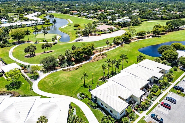 bird's eye view featuring a water view, view of golf course, and a residential view