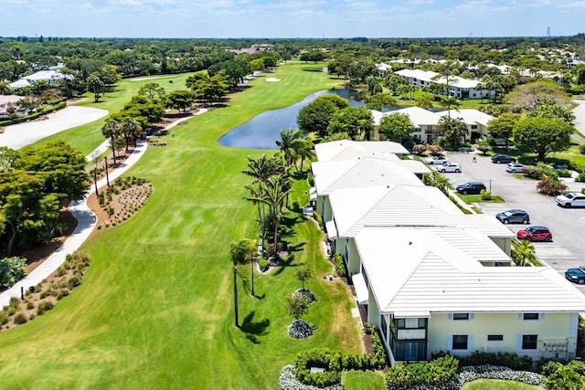 bird's eye view featuring a water view, view of golf course, and a residential view