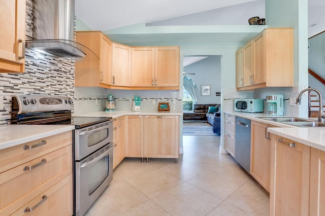 9681 Pine Trail Ct, Lake Worth, FL 33467 - kitchen with stainless steel appliances, light brown cabinets, wall chimney range hood, lofted ceiling, and decorative backsplash