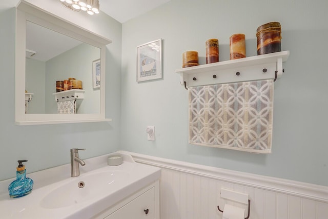 9681 Pine Trail Ct, Lake Worth, FL 33467 - bathroom featuring vanity, wainscoting, and a decorative wall