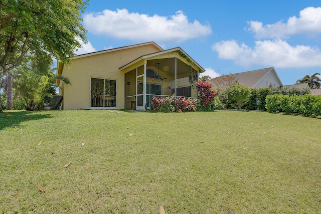 9681 Pine Trail Ct, Lake Worth, FL 33467 - back of house with a ceiling fan, a sunroom, a yard, and stucco siding