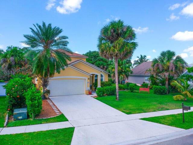9681 Pine Trail Ct, Lake Worth, FL 33467 - mediterranean / spanish-style house featuring concrete driveway, an attached garage, stucco siding, and a front lawn