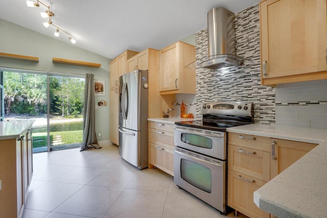 9681 Pine Trail Ct, Lake Worth, FL 33467 - kitchen with stainless steel appliances, wall chimney exhaust hood, light brown cabinetry, backsplash, and lofted ceiling