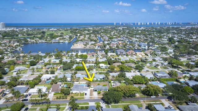 drone / aerial view with a water view and a residential view