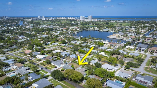 birds eye view of property featuring a water view, a residential view, and a view of city