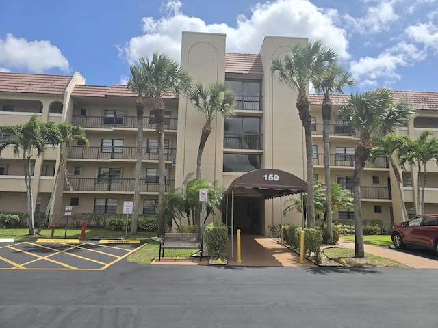 view of building exterior featuring uncovered parking