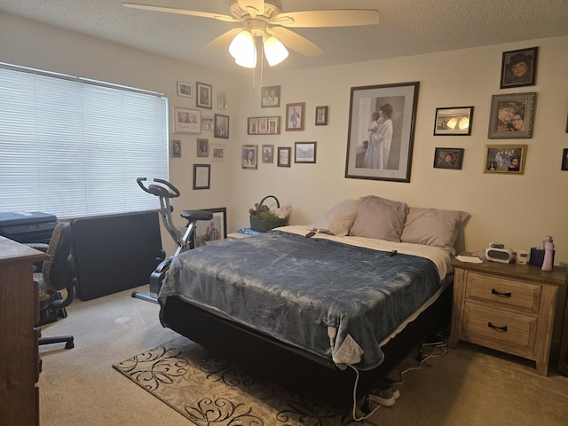 bedroom featuring carpet floors, a textured ceiling, and ceiling fan