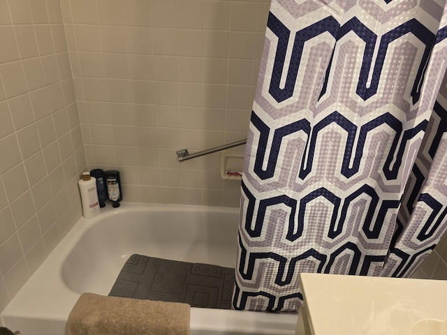 bathroom featuring a tub, a shower with curtain, and vanity