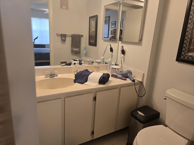 bathroom featuring vanity, tile patterned flooring, ensuite bath, and toilet