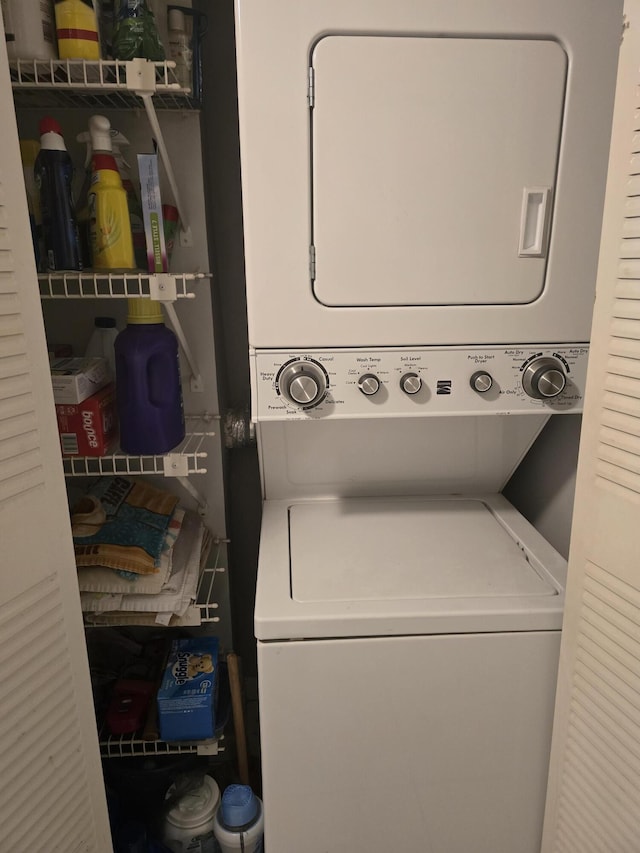 washroom with laundry area and stacked washer / drying machine