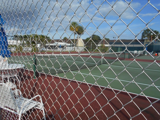 view of tennis court with fence