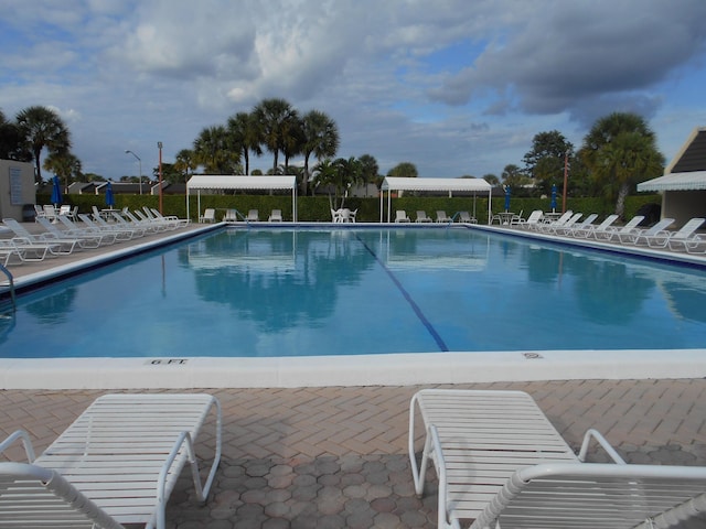community pool with a patio area