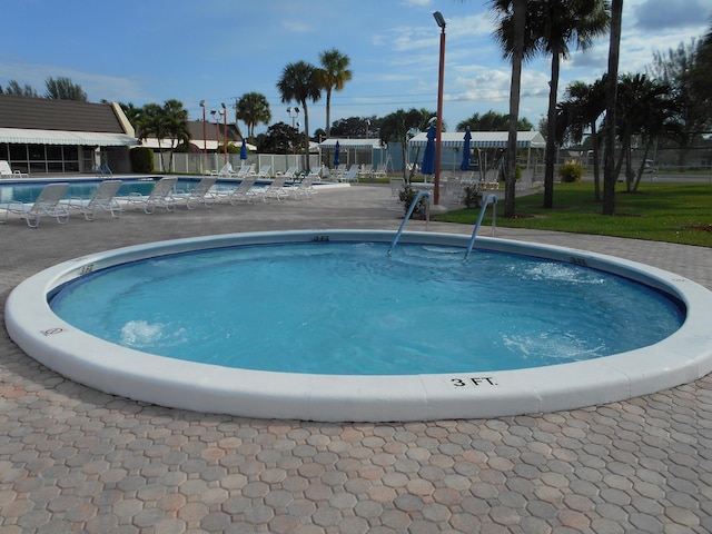 pool featuring fence and a patio