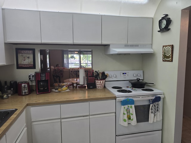 kitchen with under cabinet range hood, white cabinets, white electric stove, and light countertops