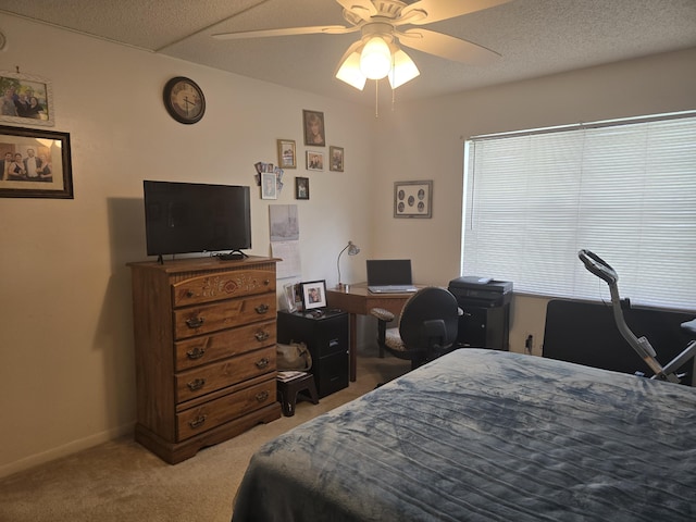 bedroom with ceiling fan, light carpet, and baseboards