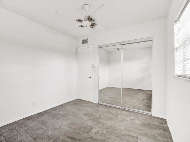 19 Abbey Ln Unit 203, Delray Beach, FL 33446 - unfurnished bedroom featuring a closet, baseboards, ceiling fan, and visible vents