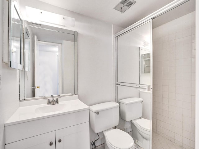 19 Abbey Ln Unit 203, Delray Beach, FL 33446 - bathroom with visible vents, tiled shower, toilet, and vanity