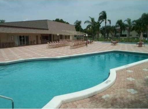 19 Abbey Ln Unit 203, Delray Beach, FL 33446 - community pool featuring a patio