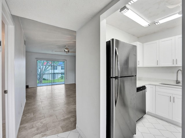 19 Abbey Ln Unit 203, Delray Beach, FL 33446 - kitchen featuring open floor plan, light countertops, white cabinets, a sink, and stainless steel appliances