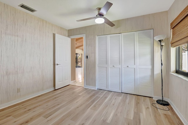 21065 Escondido Way, Boca Raton, FL 33433 - unfurnished bedroom with light wood-type flooring, a closet, a ceiling fan, and baseboards