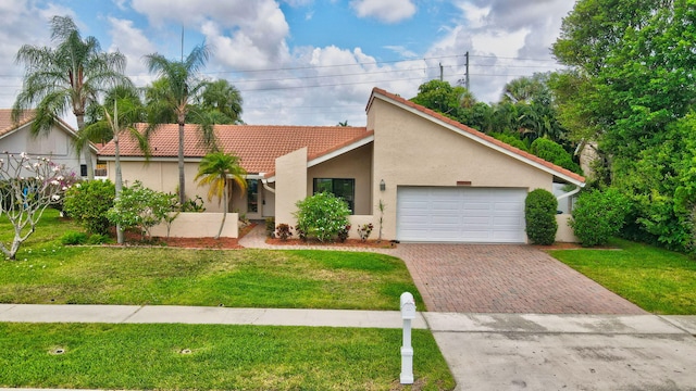 21065 Escondido Way, Boca Raton, FL 33433 - view of front of house featuring decorative driveway, stucco siding, a tiled roof, a garage, and a front yard