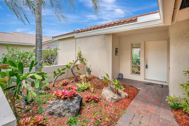 21065 Escondido Way, Boca Raton, FL 33433 - doorway to property featuring stucco siding and a tiled roof