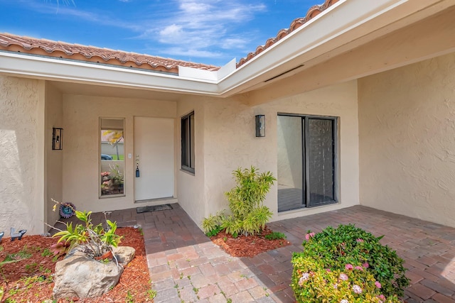 21065 Escondido Way, Boca Raton, FL 33433 - doorway to property featuring stucco siding and a tile roof