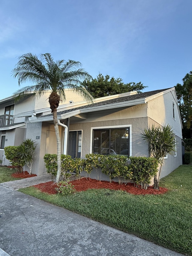 401 Shoreview Dr, Greenacres, FL 33463 - view of side of home with a lawn and stucco siding