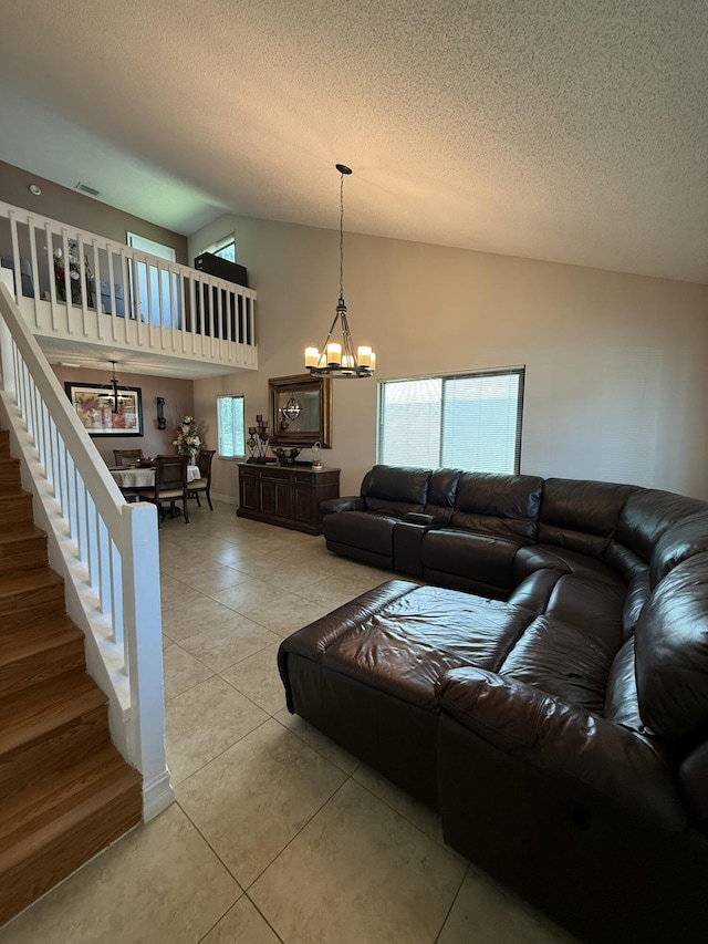 401 Shoreview Dr, Greenacres, FL 33463 - living room with a chandelier, stairway, a textured ceiling, light tile patterned floors, and high vaulted ceiling