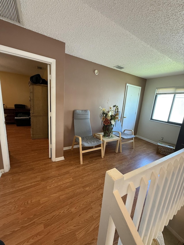 401 Shoreview Dr, Greenacres, FL 33463 - living area featuring wood finished floors, a textured ceiling, and baseboards