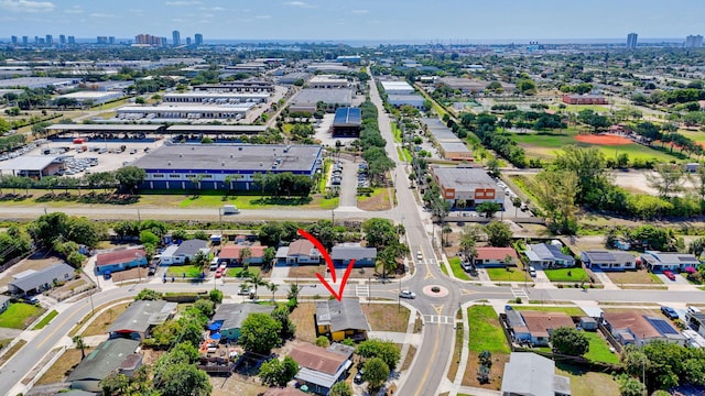 aerial view of property and surrounding area featuring nearby urban area