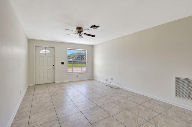 entrance foyer featuring a ceiling fan, light tile patterned flooring, and baseboards