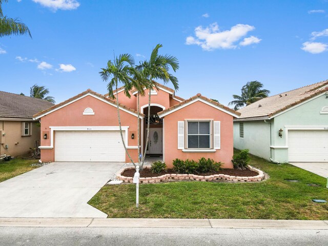 9514 Lago Dr, Boynton Beach, FL 33472 - view of front of home with a garage, a front lawn, stucco siding, and concrete driveway