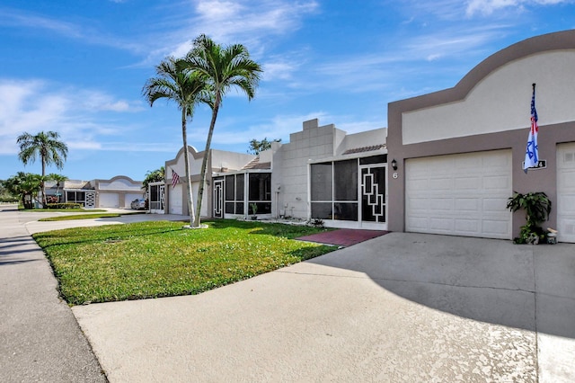 9214 Flynn Cir # 6, Boca Raton, FL 33496 - view of front of house with an attached garage, stucco siding, a front yard, and concrete driveway