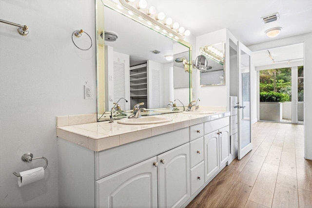 2774 S Ocean Blvd Unit 106, Palm Beach, FL 33480 - bathroom featuring double vanity and wood finished floors