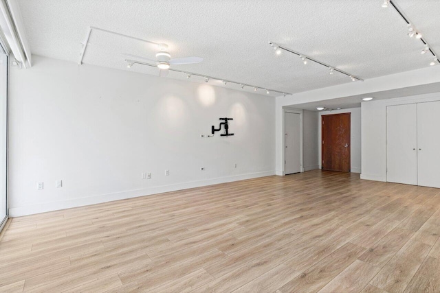 2774 S Ocean Blvd Unit 106, Palm Beach, FL 33480 - spare room featuring rail lighting, light wood-type flooring, baseboards, a textured ceiling, and a ceiling fan