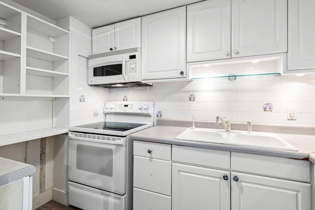 2774 S Ocean Blvd Unit 106, Palm Beach, FL 33480 - kitchen with white appliances, a sink, white cabinets, backsplash, and light countertops