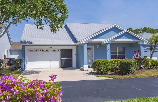 460 NW Turin Ct, Port Saint Lucie, FL 34986 - view of front of property featuring concrete driveway, roof with shingles, a garage, and stucco siding