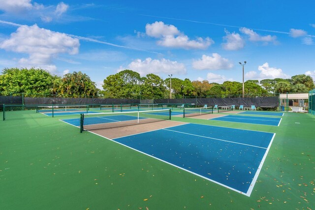 460 NW Turin Ct, Port Saint Lucie, FL 34986 - view of tennis court with fence and view of wooded area