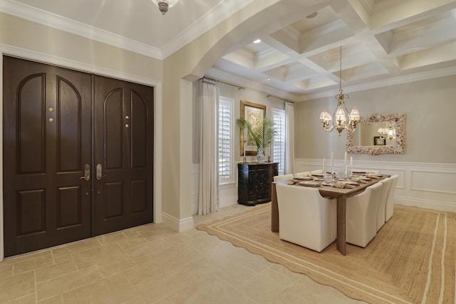 10841 SE Arielle Ter, Jupiter, FL 33469 - entrance foyer with crown molding, a decorative wall, arched walkways, beamed ceiling, and coffered ceiling
