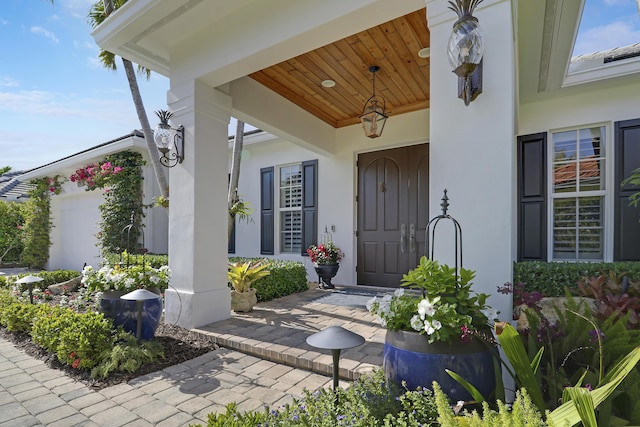 10841 SE Arielle Ter, Jupiter, FL 33469 - entrance to property with a garage, stucco siding, and a porch