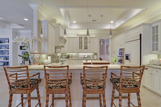 10841 SE Arielle Ter, Jupiter, FL 33469 - kitchen with backsplash, stainless steel double oven, crown molding, a peninsula, and glass insert cabinets