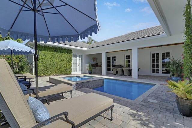 10841 SE Arielle Ter, Jupiter, FL 33469 - outdoor pool featuring a patio area, french doors, and an in ground hot tub