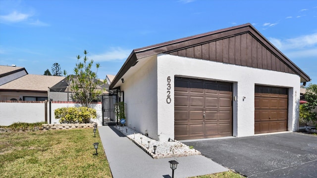 6320 Wedgewood Ter Unit 6320, Tamarac, FL 33321 - view of home's exterior with a yard, fence, driveway, and stucco siding